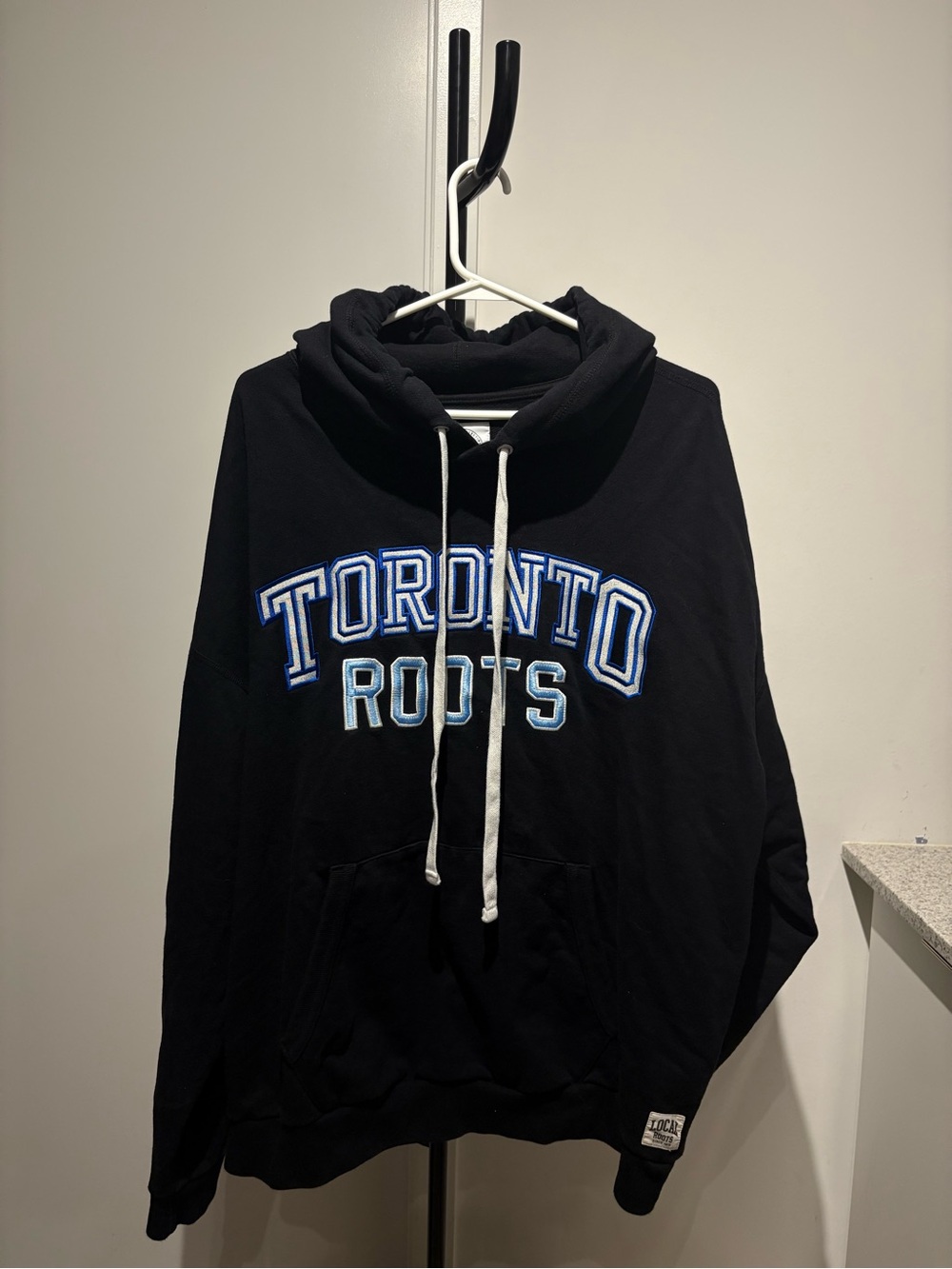 Roots Black Zip-Up Hoodie with Blue and White Toronto Lettering